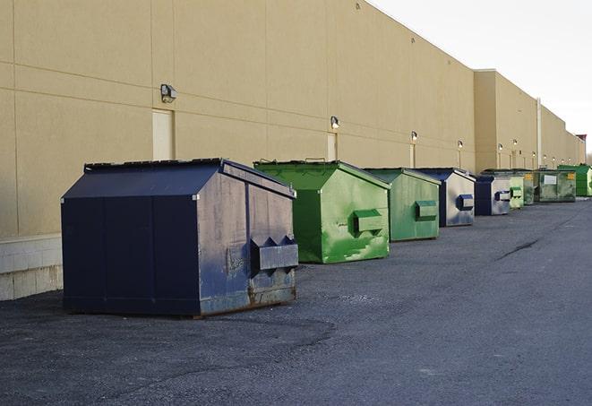 construction dumpsters on a worksite surrounded by caution tape in Burlington